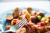 fork in a bowl of peppers and sausage 