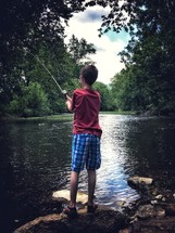 boy fishing in a river