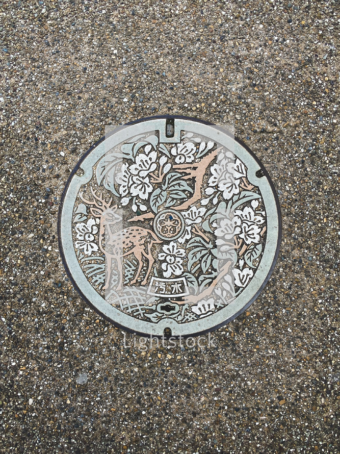 deer on a sewer manhole cover 