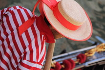Gondolier in traditional striped top, straw hat with flowing ribbon 
