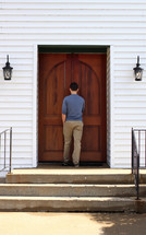 a young man entering a church 