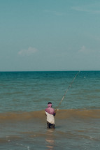 fisherman fishing in the ocean 