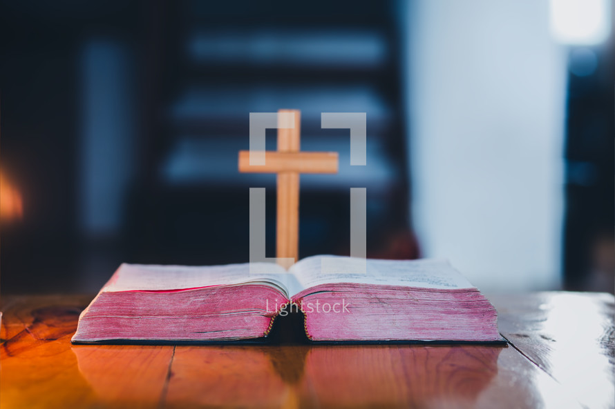 cross and open BIble on a table 