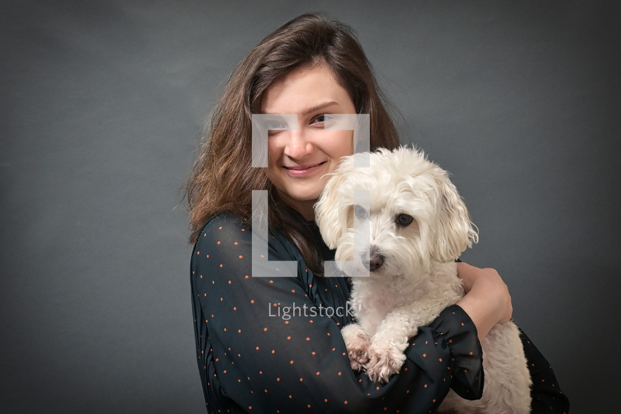 girl holding a dog 
