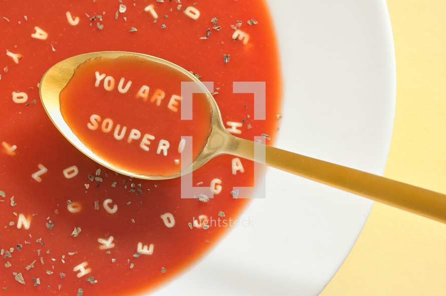 Tomato Soup With Letter Noodles On Spoon