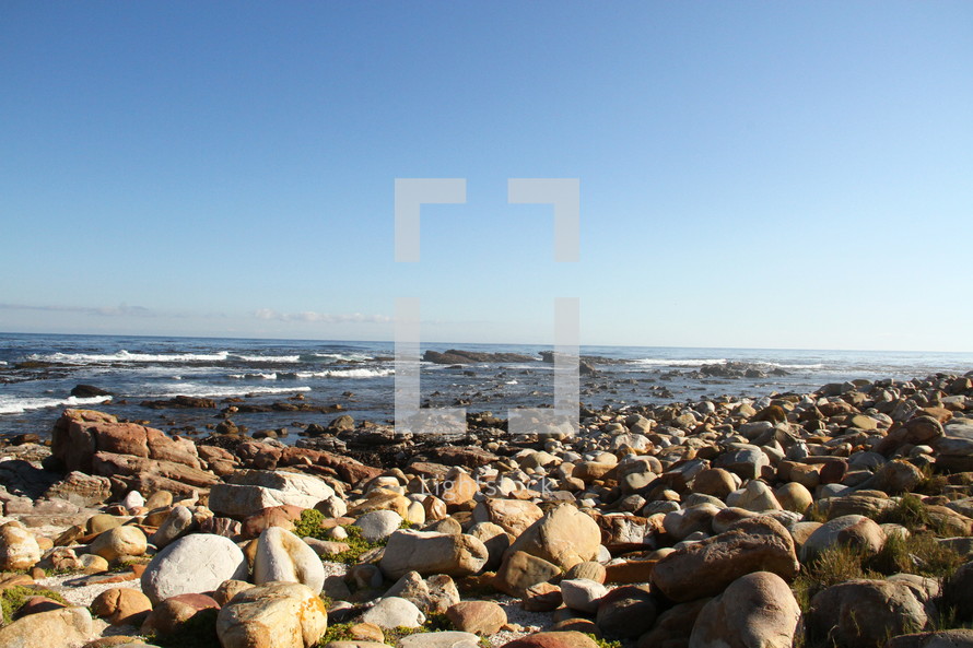 A seashore covered in boulders.