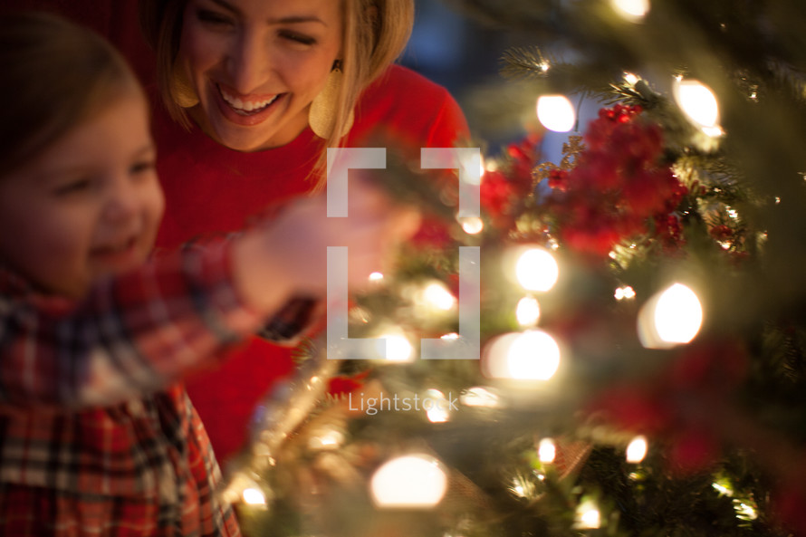 mother and daughter near a Christmas tree 