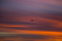 helicopter in the sky at sunset 