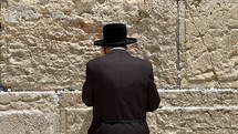 Orthodox man praying at the Western Wall