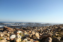 A seashore covered in boulders.