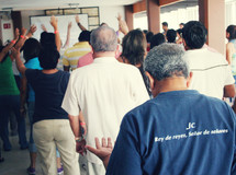 hands raised in praise to God at a worship service