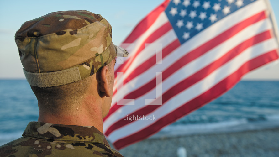 Military next to flag as patriotism concept