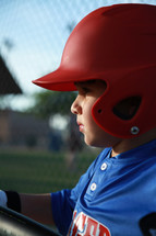 child in a baseball batters helmet 