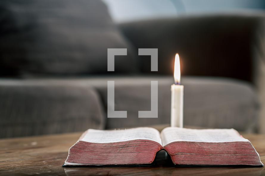 candle and open Bible 