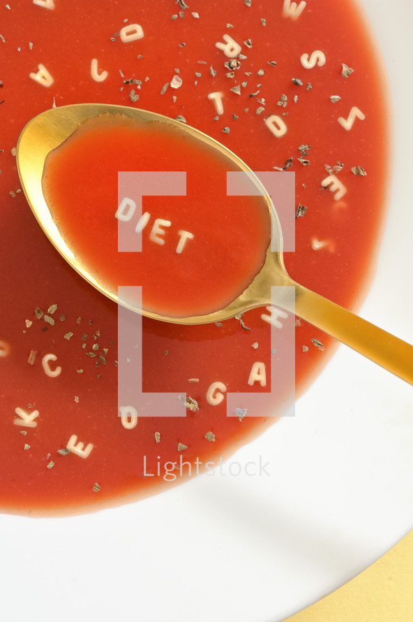 Tomato Soup With Letter Noodles On Spoon