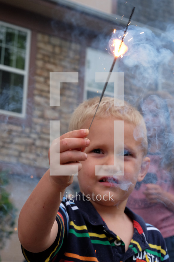 a child holding a sparkler 