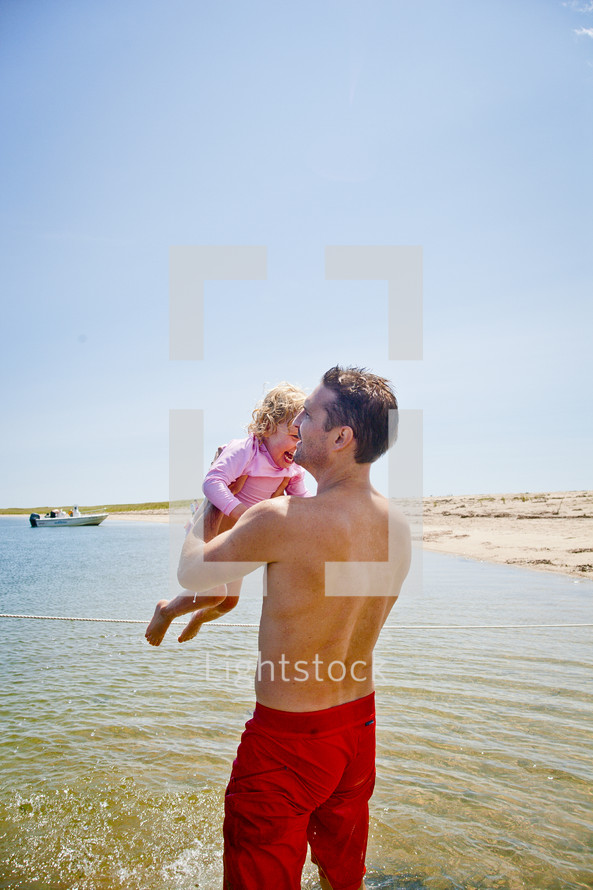 a father and daughter on a beach 