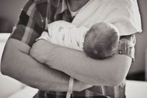 a man holding a baby 