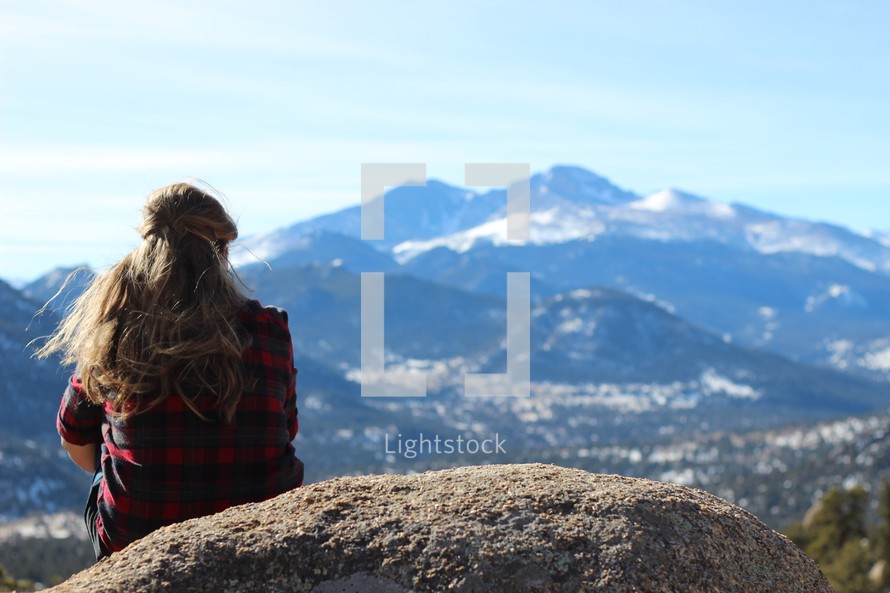 woman looking out at mountains 