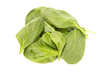 pile of Spinach Leaves on a White Background