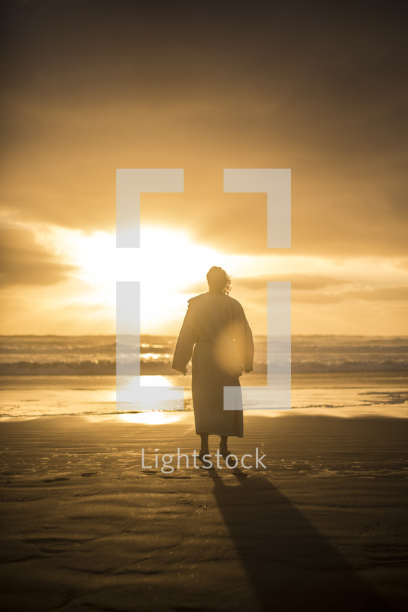 Jesus standing on a shore at sunrise 