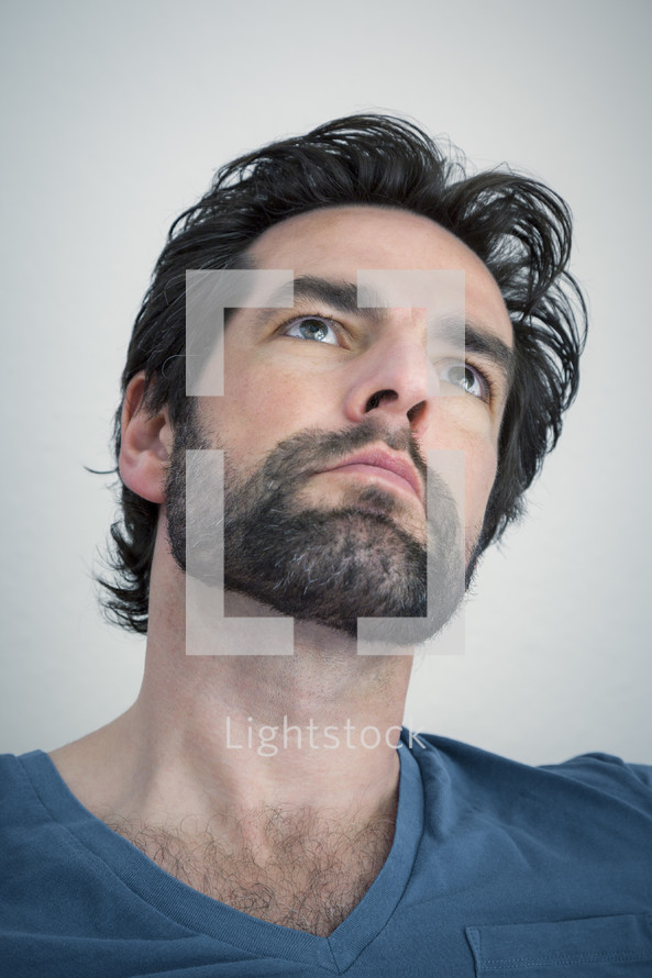 bearded man looking upwards 