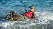 Military man with camouflage and life jacket as safety concept
