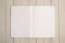 open notebook on white wood background 