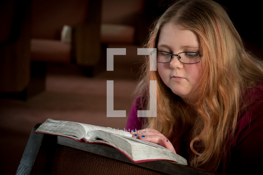 Teen girl reading a Bible 