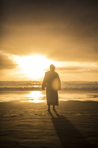 Jesus standing on a shore at sunrise 