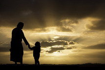 silhouette of Jesus walking holding hands with a little girl 
