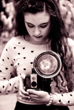 woman holding a vintage camera 