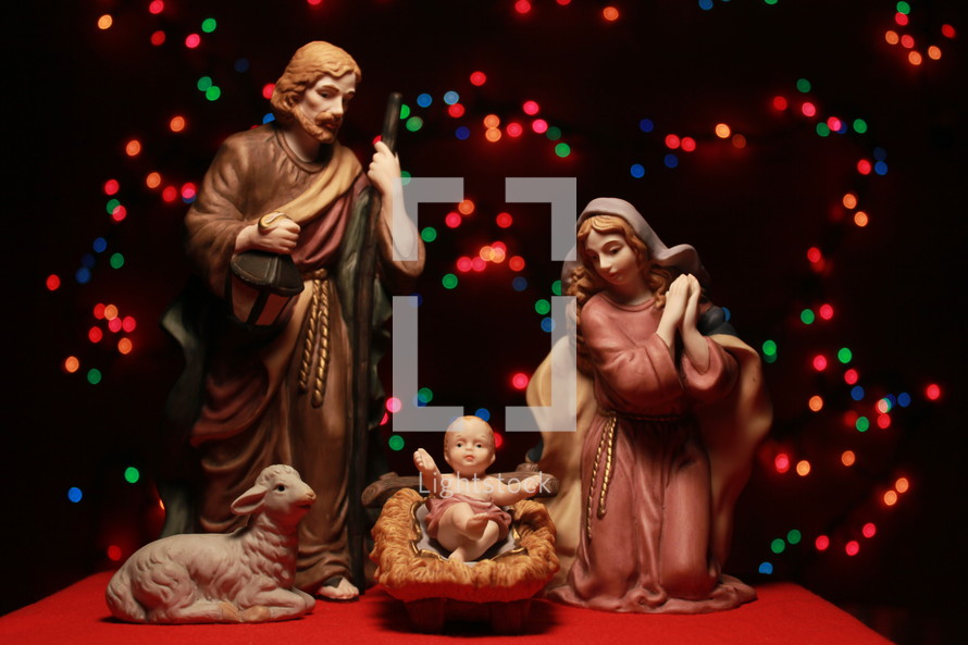nativity with holy family and colorful bokeh lights 