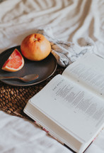 grapefruit and open Bible 