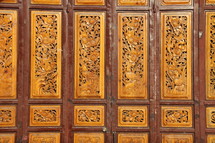 Chinese paneled door with ornate carved detail 