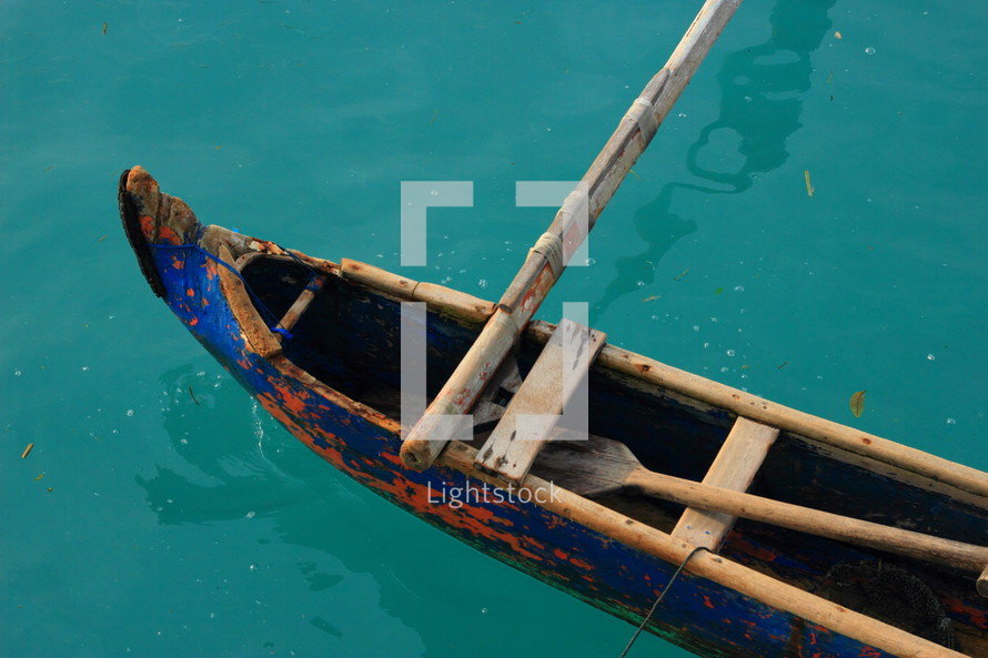 canoe on blue water 