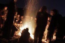 Teens around a campfire.