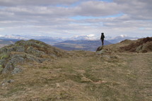 man standing on a mountain top 