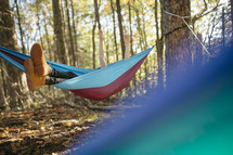 man resting in a hammock in the forest 