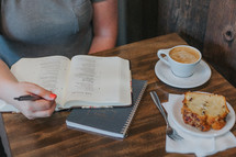 a woman reading a Bible over breakfast 
