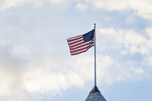 An American flag on a top of a roof 