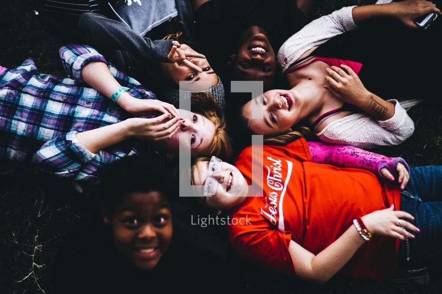 a group of kids lying on the ground 