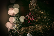 ornaments on a Christmas tree and bokeh lights 