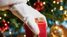 Santa Claus delivering presents under the Tree