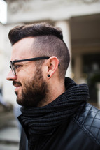 side profile of a man with a beard and unique haircut 