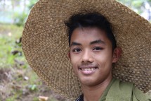 a young farmer man in a straw hat 
