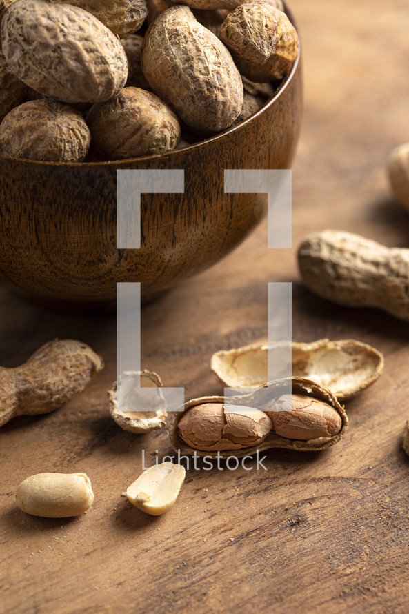 A Bowl of In Shell Peanut on a Dark Wooden Table