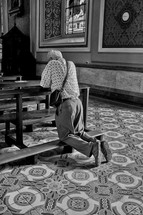 elderly man alone in a church praying 