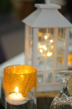 lantern and candle on a table 