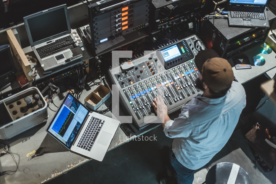 a man behind a soundboard 